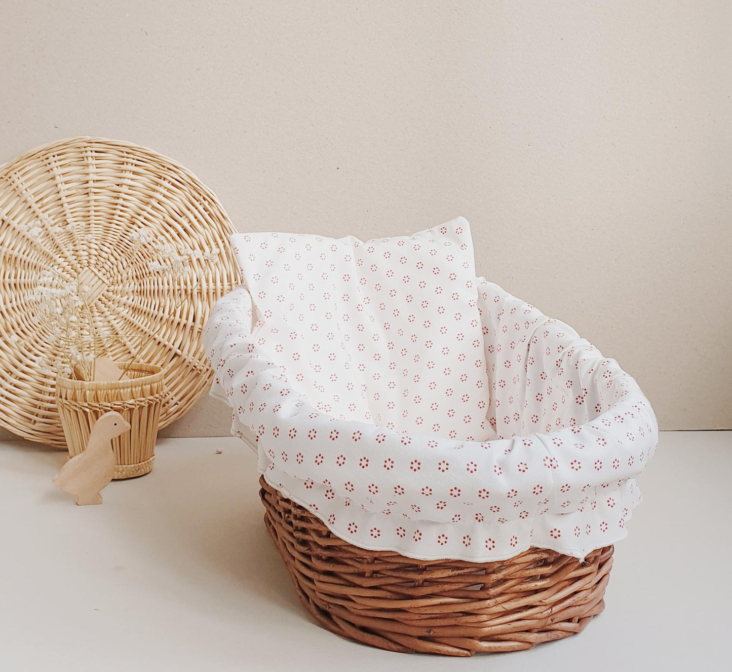 rattan doll bed with linen and cushions coconeh